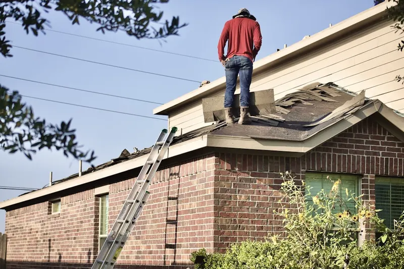 Professional roofer working on a residential roof in Millersport